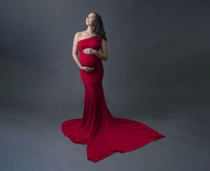 orange county woman in long red gown in a studio