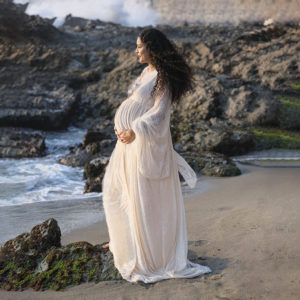 pregnant women in white dress on beach