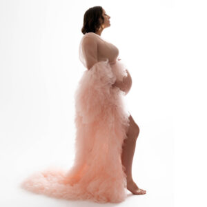 pregnant woman in pink ruffled dress
