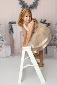 girl in dress on a ladder