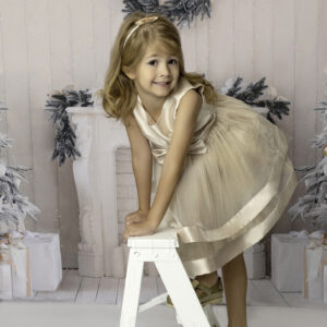 Anaheim girl in light yellow dress standing on a white ladder