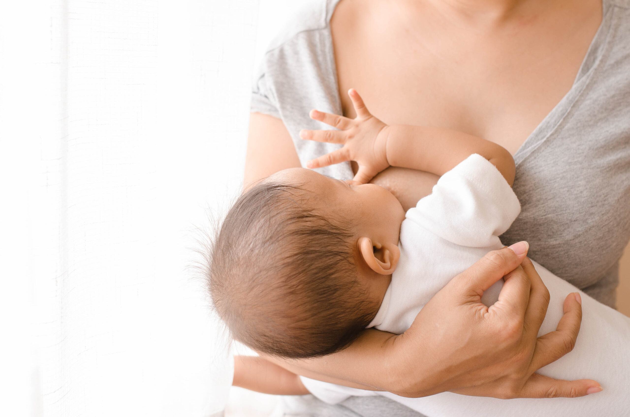 A mom breastfeeding her baby in the East Bay