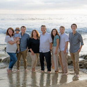 Family standing on the sand in Laguna Beach.