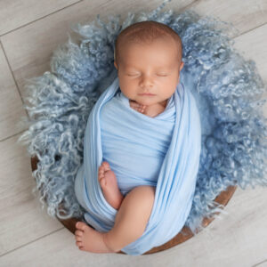 newborn boy in Orange County laying on blue fur