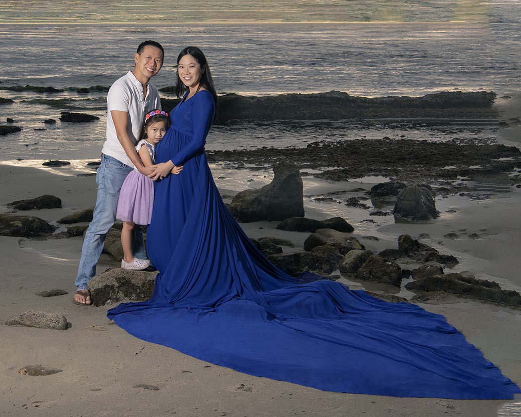 family posing on the sand at Laguna Beach