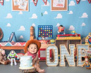 bay-area-one-year-old boy-sitting on the floor with a cake