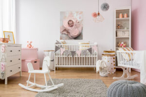 A San Francisco newborn baby girl's room has a crib and a white rocking horse in it.